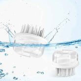 Two white scalp massagers with water droplets and splashes on a light blue background
