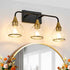 Modern ceiling light fixture with three glass bulbs in a room with a mirror and flowers.