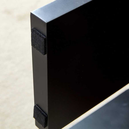 Protective pads on black leg of Walnut MDF Coffee Table, ensuring floor safety and stability in modern home environments.