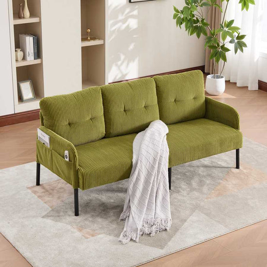 Green sofa with a white blanket in a living room setting