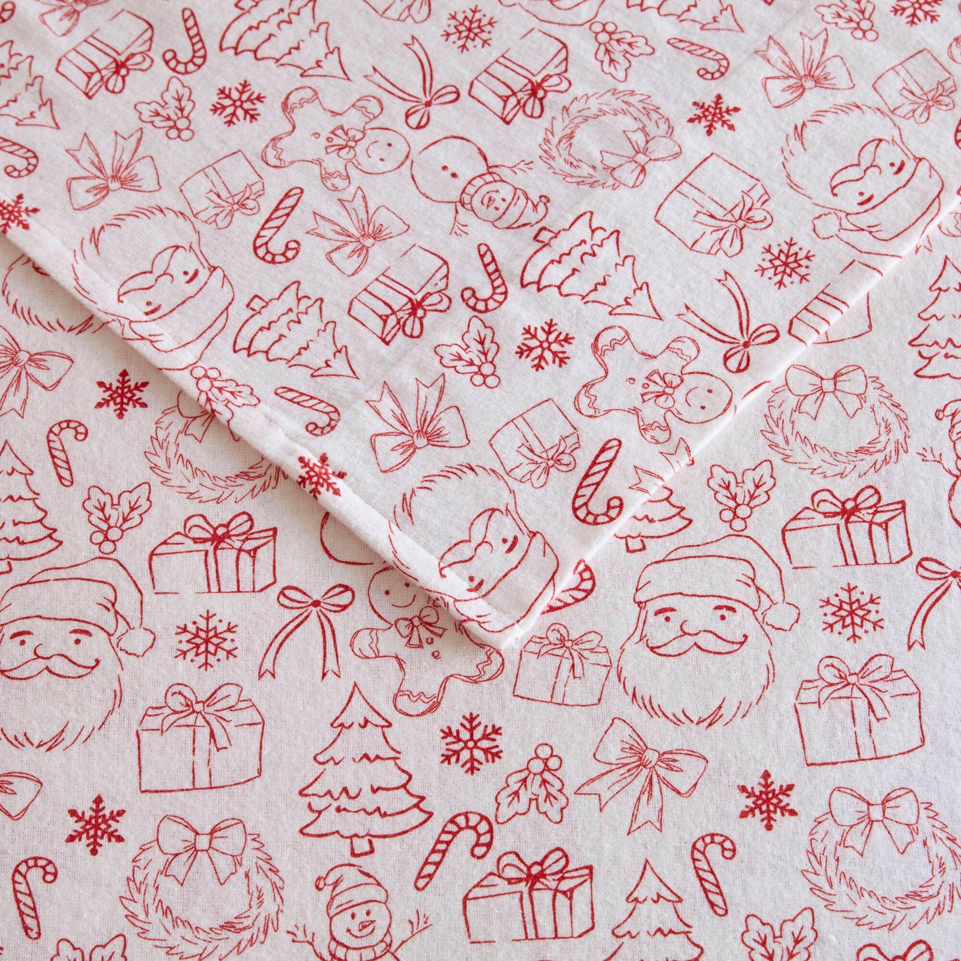 Detailed view of Twin XL Cotton Flannel Sheet Set with red holiday doodles including Santa, gifts, and snowflakes on soft fabric.