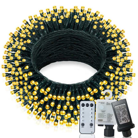 Coiled string light set with remote control and power adapter on a white background