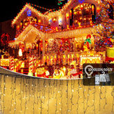 House roofline decorated with warm white 1000 LED icicle curtain fairy lights
