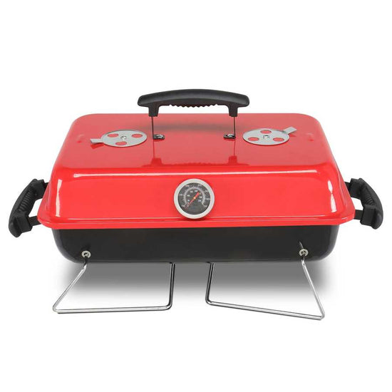 Red portable grill with black handle on a white background