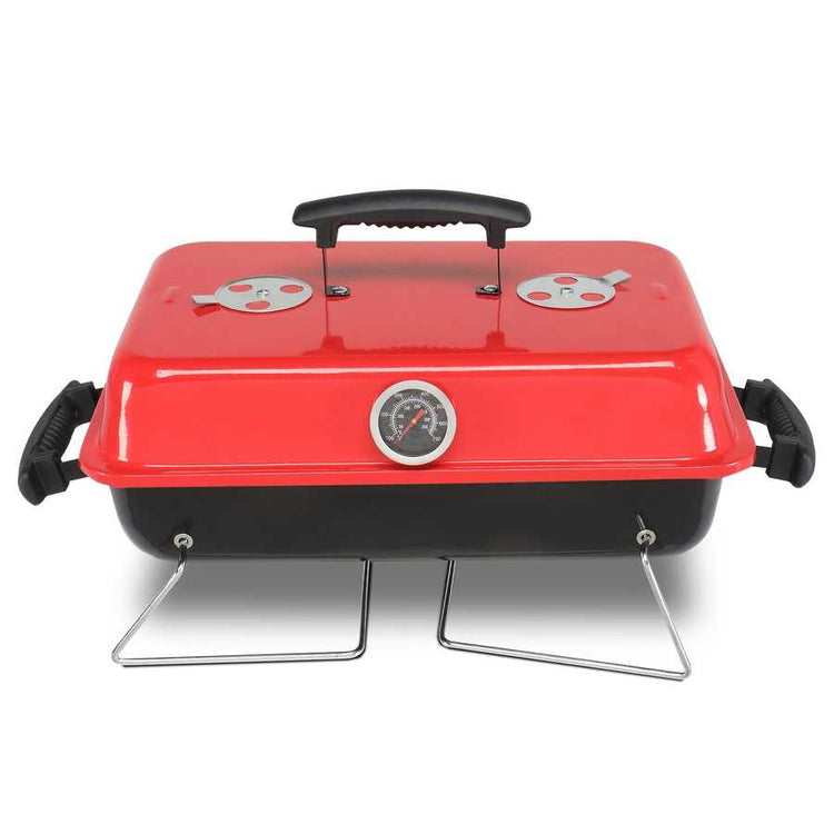 Red portable grill with black handle on a white background