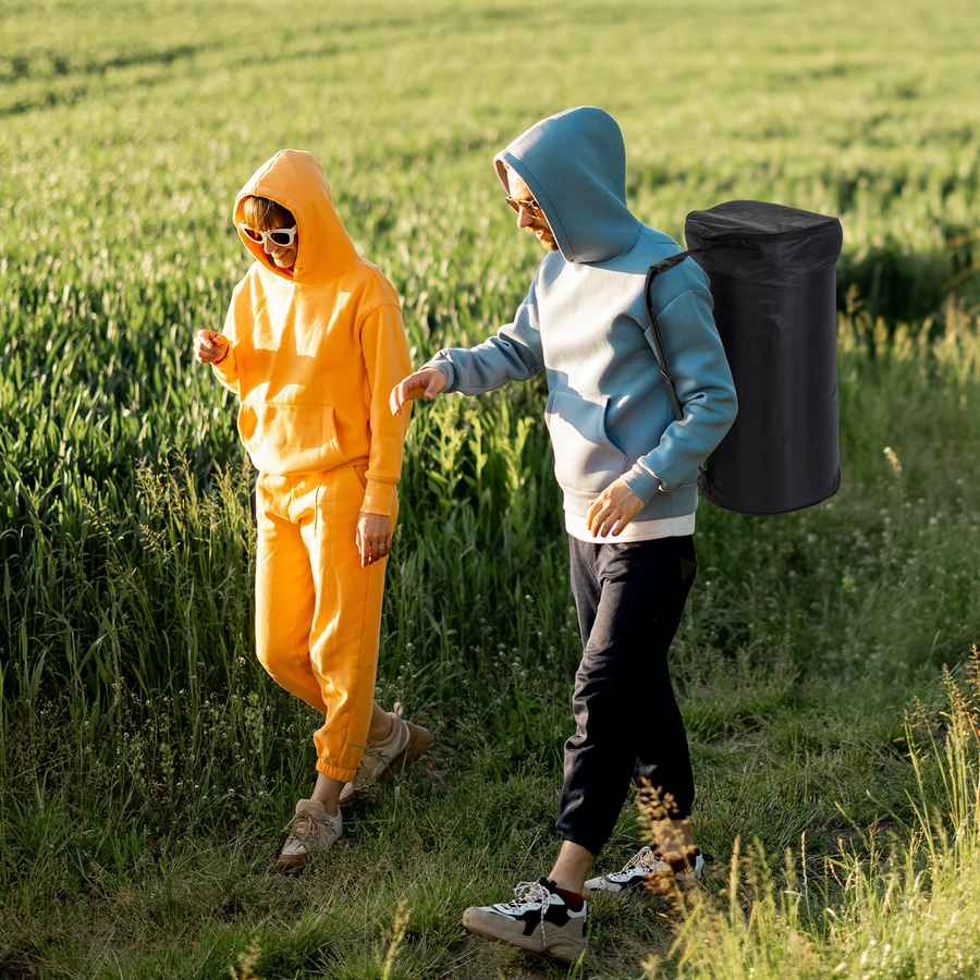 Two people in colorful outfits standing in a field