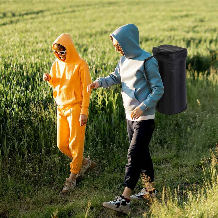 Two people in colorful outfits standing in a field