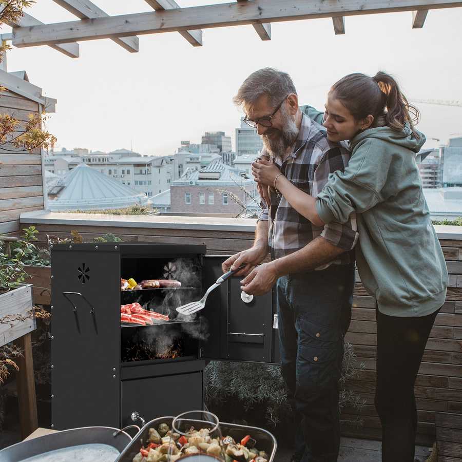 Man and woman grilling on a rooftop with cityscape in the background