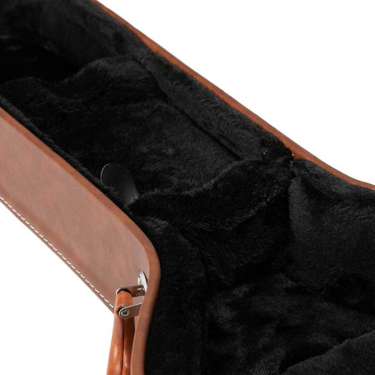 Close-up of a guitar case with black interior lining and brown exterior.