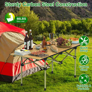 Camping table with food and drinks next to a tent in a scenic outdoor setting