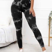 Women's compression fit scrunch leggings in black marble design, offering high waist support and shaping for fitness and yoga routines.