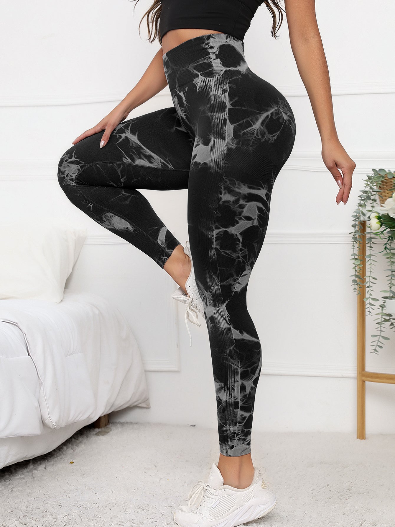 High waist scrunch leggings in black with tie-dye pattern, designed for tummy control and flattering fit during activewear sessions.