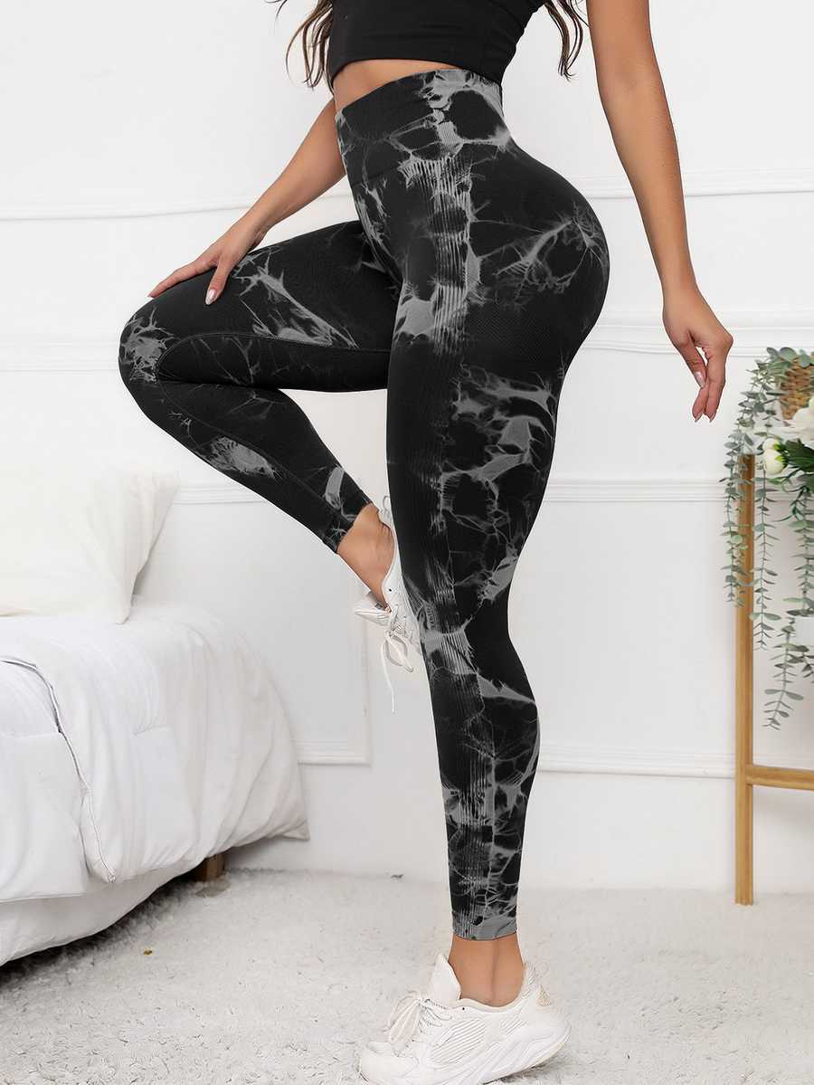 High waist scrunch leggings in black with tie-dye pattern, designed for tummy control and flattering fit during activewear sessions.