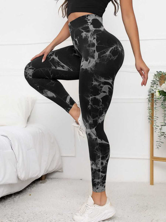 High waist scrunch leggings in black with tie-dye pattern, designed for tummy control and flattering fit during activewear sessions.