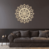 Decorative mandala wall sticker on a dark wall above a brown sofa.