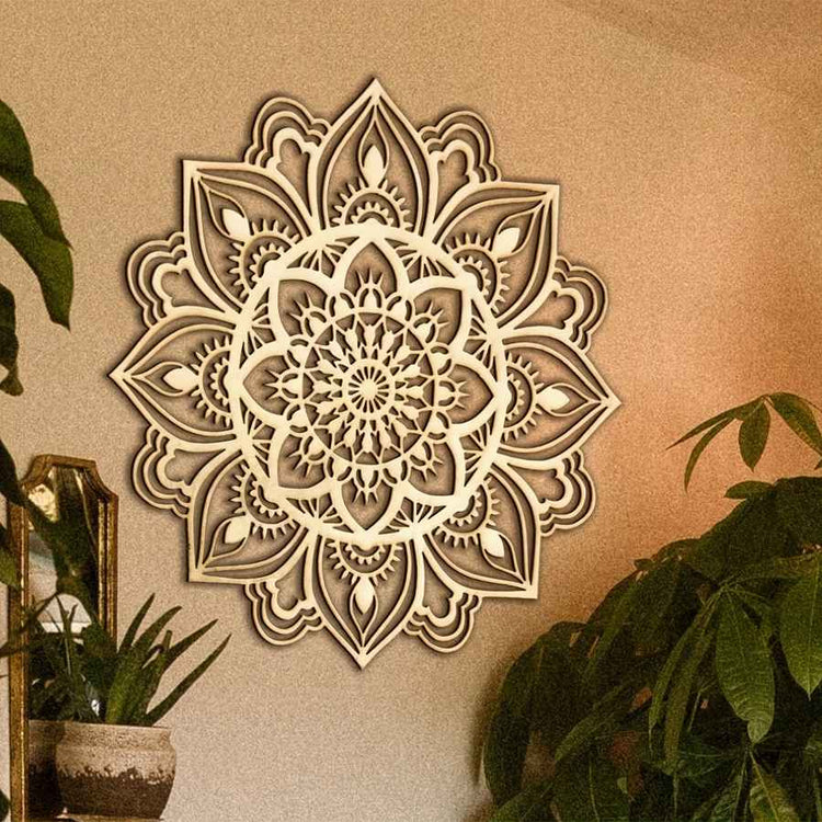 Decorative wall mandala on a beige wall with plants around