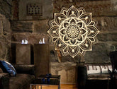 Decorative mandala wall art in a living room with stone walls and furniture.