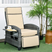 Gray wicker recliner chair with beige cushions in an outdoor setting with plants.