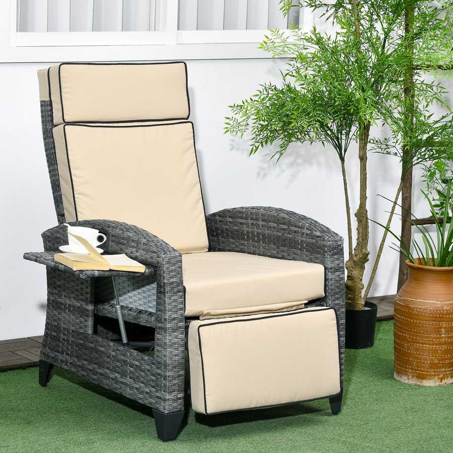 Gray wicker recliner chair with beige cushions in an outdoor setting with plants.