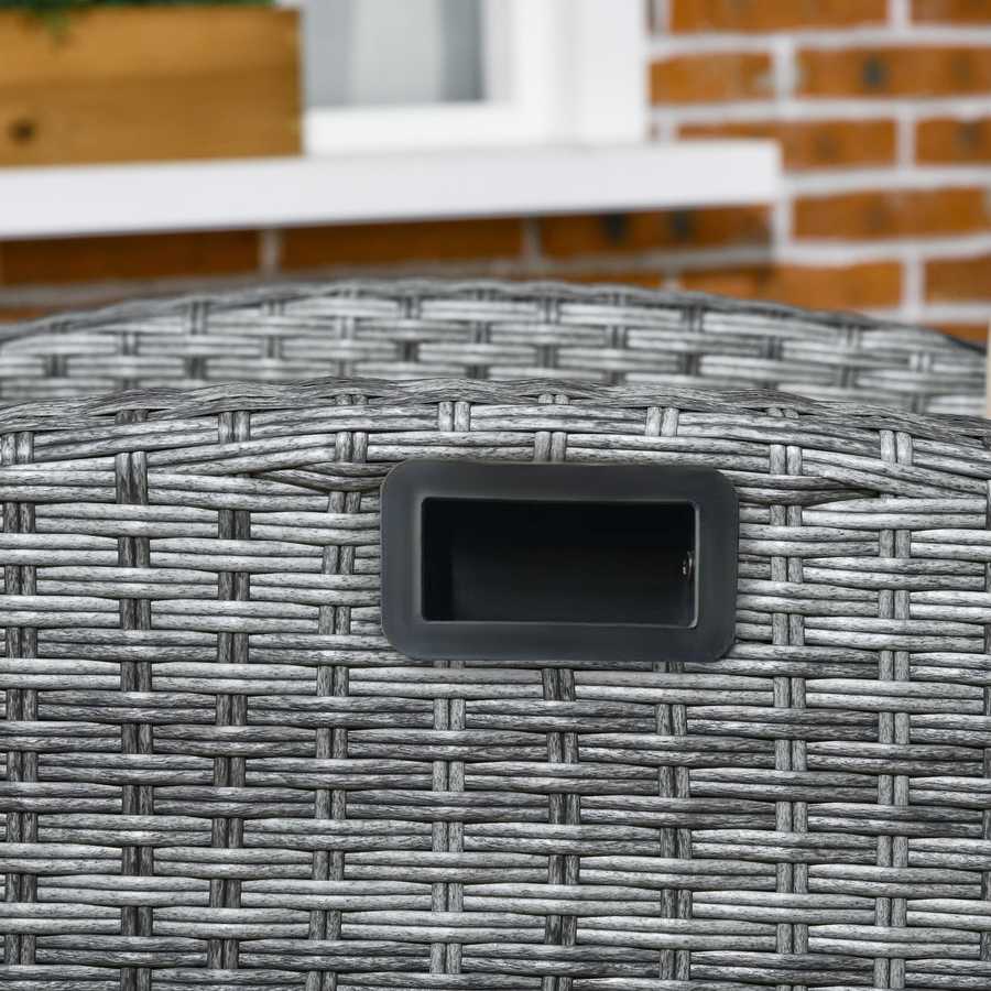 Close-up of a woven outdoor table with a black latch on a blurred brick wall background