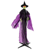 Halloween witch decoration with purple cape and black hat on a stand.