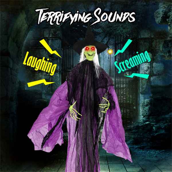 A Halloween decoration of a creepy witch with a green face, black hat and dress, and a flowing purple cape, set in a dark stone alleyway. The text &