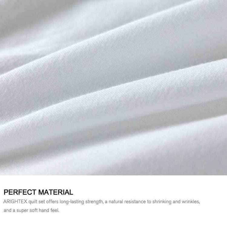 Close-up of white quilt fabric with text about quilt set material