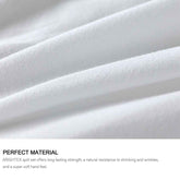 Close-up of white quilt fabric with text about quilt set material