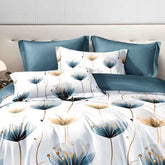 Floral patterned bedding set with blue and white pillows on a bed.