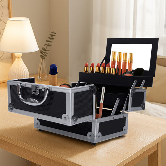 Aluminum makeup storage bag with mirror and key, open on vanity table displaying cosmetics in fold-out compartments. Ideal for home or travel use.