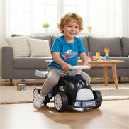 Kids Ride-On Car with Music - Smiling toddler riding the shark-themed car indoors, ideal for active play and coordination training.