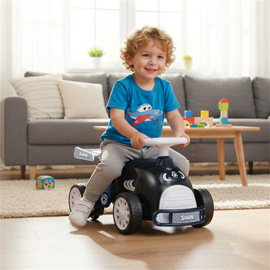 Kids Ride-On Car with Music - Smiling toddler riding the shark-themed car indoors, ideal for active play and coordination training.