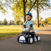 Kids Ride-On Car with Music - Child riding shark-themed toy outdoors in park, perfect for outdoor play and physical activity.