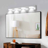 Large wall-mounted mirror with lights above a wooden desk in a room.