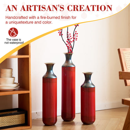 Handcrafted droplet shaped metal floor vases with fire-burned finish, displayed in a cozy home setting for decorative use.