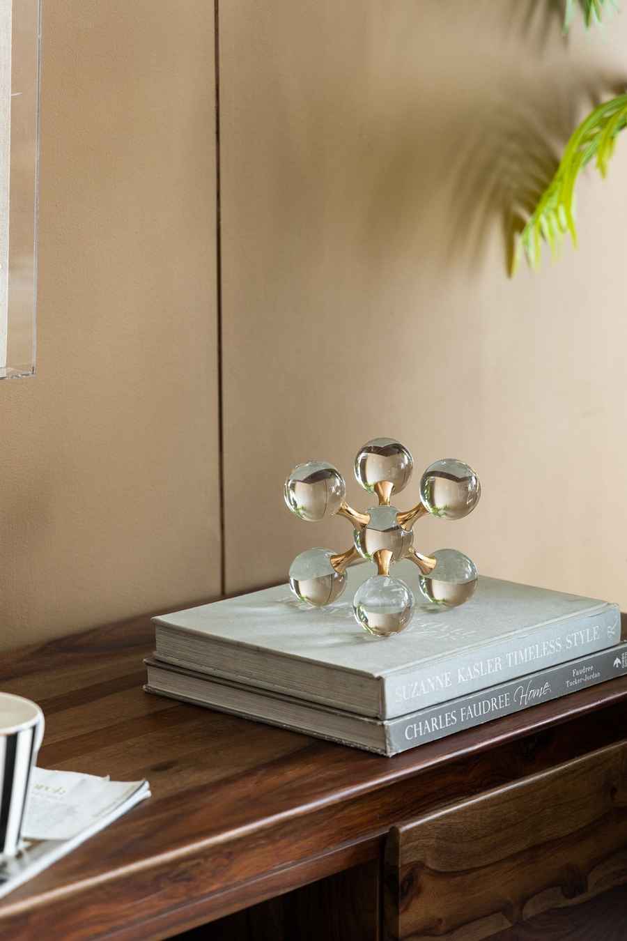 Decorative sculpture on a stack of books with a neutral background