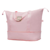 Pink tote bag with a visible brand label on a white background