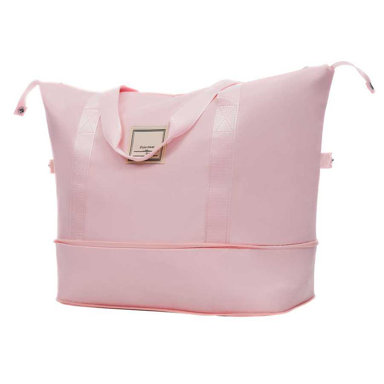 Pink tote bag with a visible brand label on a white background