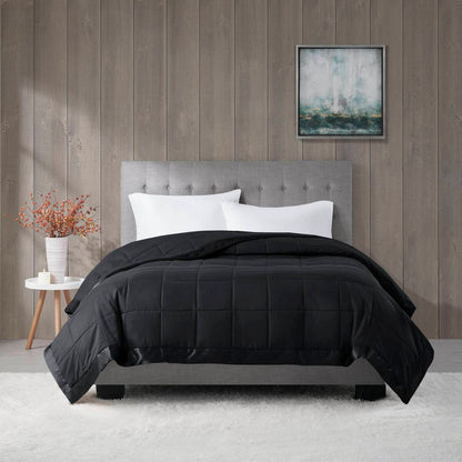 Black Lightweight Down Alternative Blanket on a bed in a cozy room setting, perfect for enhancing comfort and modern bedroom style.