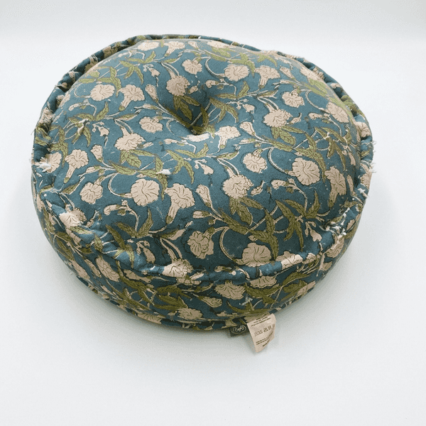 Round floral cushion with a tag on a white background