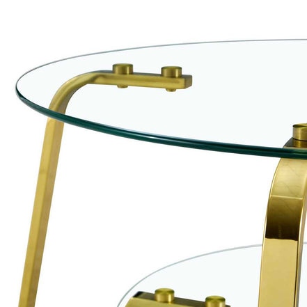 Detail of tempered glass top with gold metal brackets on vintage coffee table, showcasing smooth edge finish.