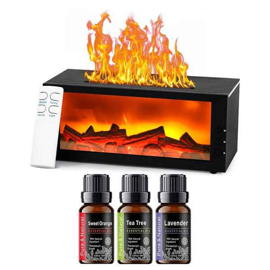 A tabletop electric fireplace with glowing orange and yellow flames, shown with a white remote control and four essential oil bottles labeled Sweet Orange, Tea Tree, and Lavender on a white background.