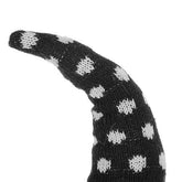 Close-up of black and white polka dot knit hat on gnome, featuring a long, pointed shape with cozy texture for Halloween décor
