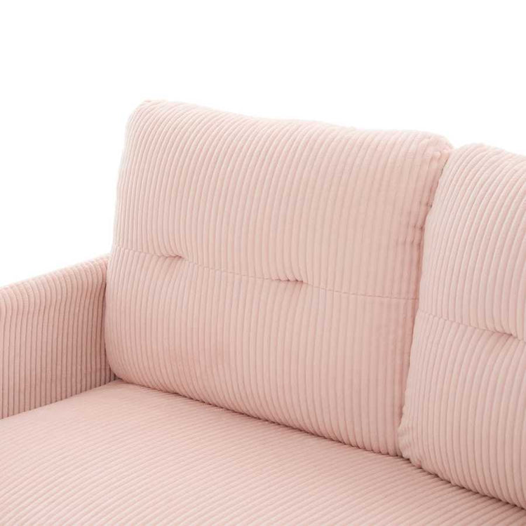 Close-up of a pink corduroy sofa with a white background