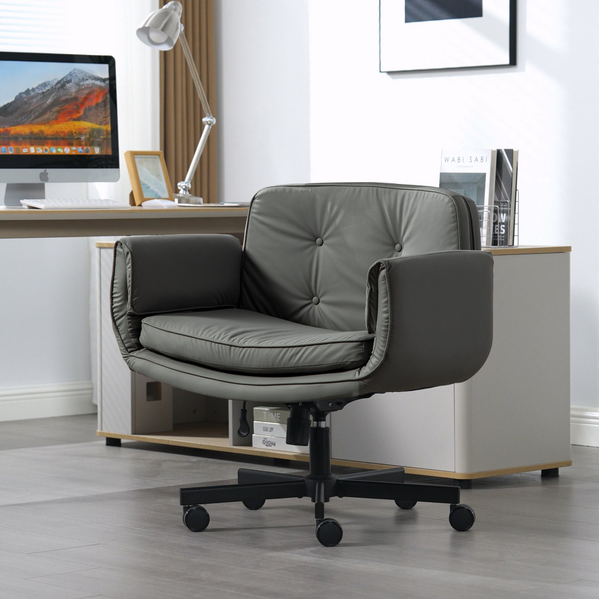 Gray office chair in a modern office setting with a desk and computer monitor.