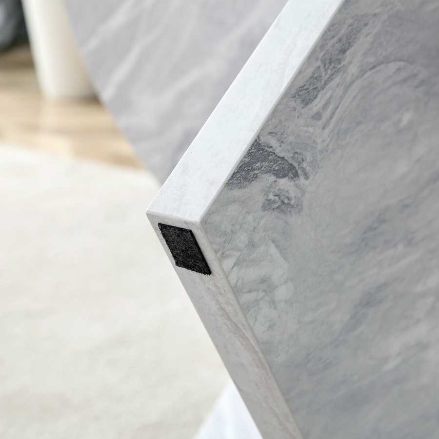 Bottom corner of MDF white round coffee table leg with protective felt pad, designed to prevent floor scratches.