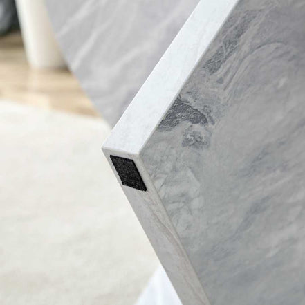 Bottom corner of MDF white round coffee table leg with protective felt pad, designed to prevent floor scratches.