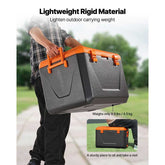 Person carrying a large gray and orange toolbox outdoors