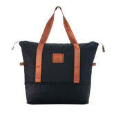 Black and brown travel duffel bag with adjustable shoulder straps and telescoping handle for easy transport