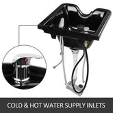 Black ceramic sink with cold and hot water supply inlets on a white background